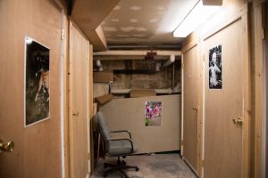 Photograph of artworks by Zak Arctander hanging in the basement of the Williamstown Municipal Building. From left: "Chip," 2015; "Orchids," 2015; "Telenoid," 2017. Inkjet prints, 22x17 in.