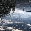 Still image from an airplane flying to Malawi, using the 4th Wall virtual reality app to project the art of Nancy Baker Cahill, Williams Class of 1992, on the image.