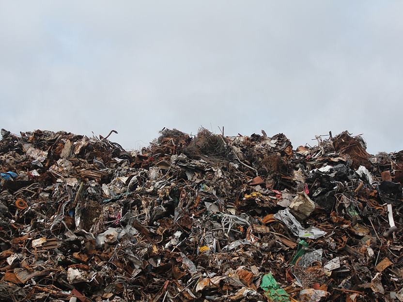 Photograph showing a hill of trash from a dump.
