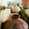 photograph of urns being filled with water supplied by a solar-powered well in rural Pakistan, a project developed by Hamza Farrukh, Williams Class of 2015.