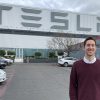 Photo of alumnus Dan Wohl standing outside a Tesla building