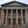 Chapin Hall at Williams College is seen from the front and its columns are decorated with banners spelling out V-O-T-E.