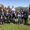 Students leaping into the air with mountains in the background