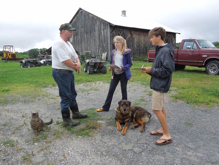 From left: farmer Neil Oleson is interviewed by students Samantha Murray, Class of 2014, and David Nolan, Class of 2013, for the Keep Berkshire Farming project.