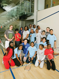 Christian Henze, Williams Class of 2010 (back row, left), Jessica Lovaas, Williams 2006 (back row, right), and Tony Maruca, Williams 2008, (front row, center), with StreetSquash students in Harlem.