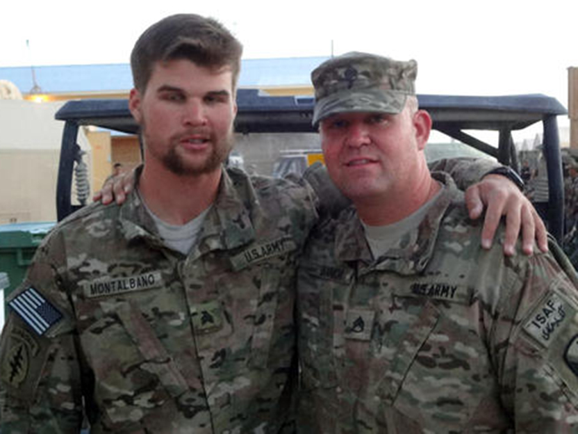 A photo shows alumnus Hank Montalbano with his arm around a colleague from the military.