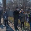 People who are eligible and registered wait in line to get COVID-19 vaccine at NYC Health Department Vaccine Hub at Hillcrest High School in Queens.